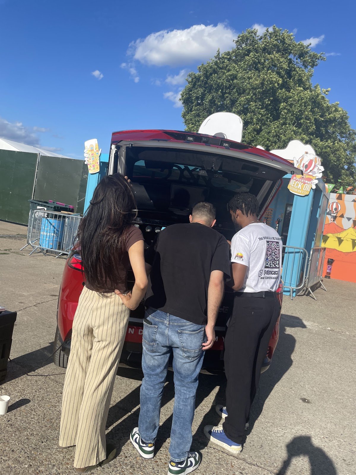 Guests trying the decks in the DJ car at a Beavertown event