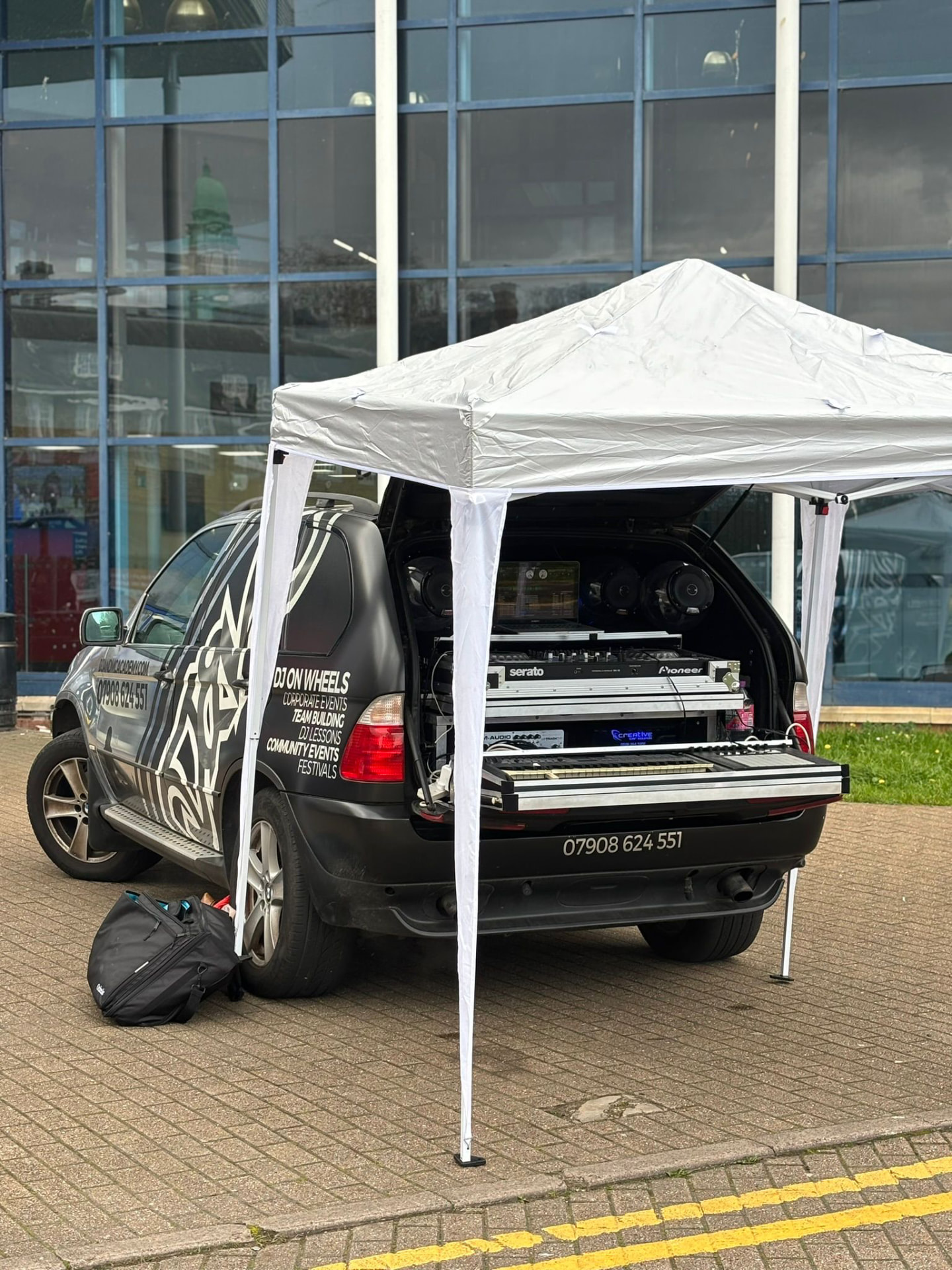 DJ on Wheels mobile setup with full DJ rig at a corporate event