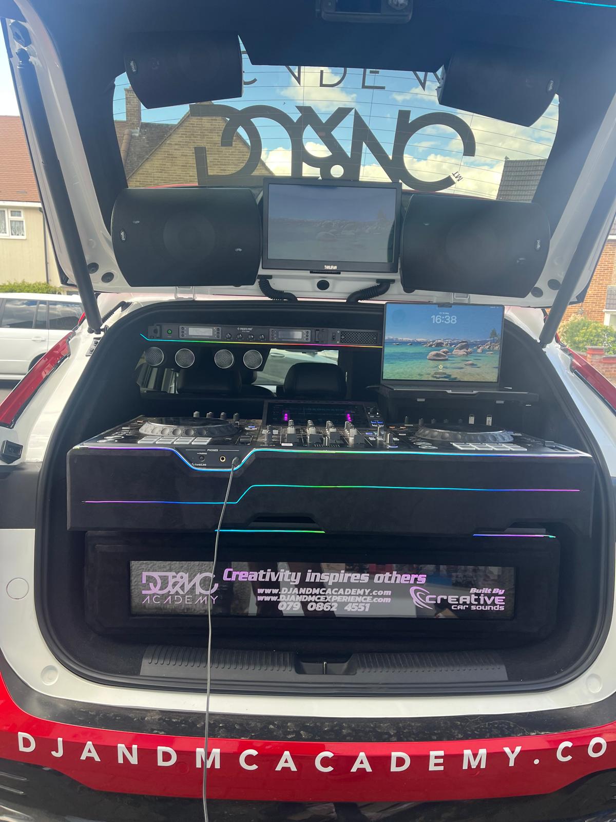 The DJ car boot fitted with decks, speakers, screens and wireless mics, branded DJ & MC Academy