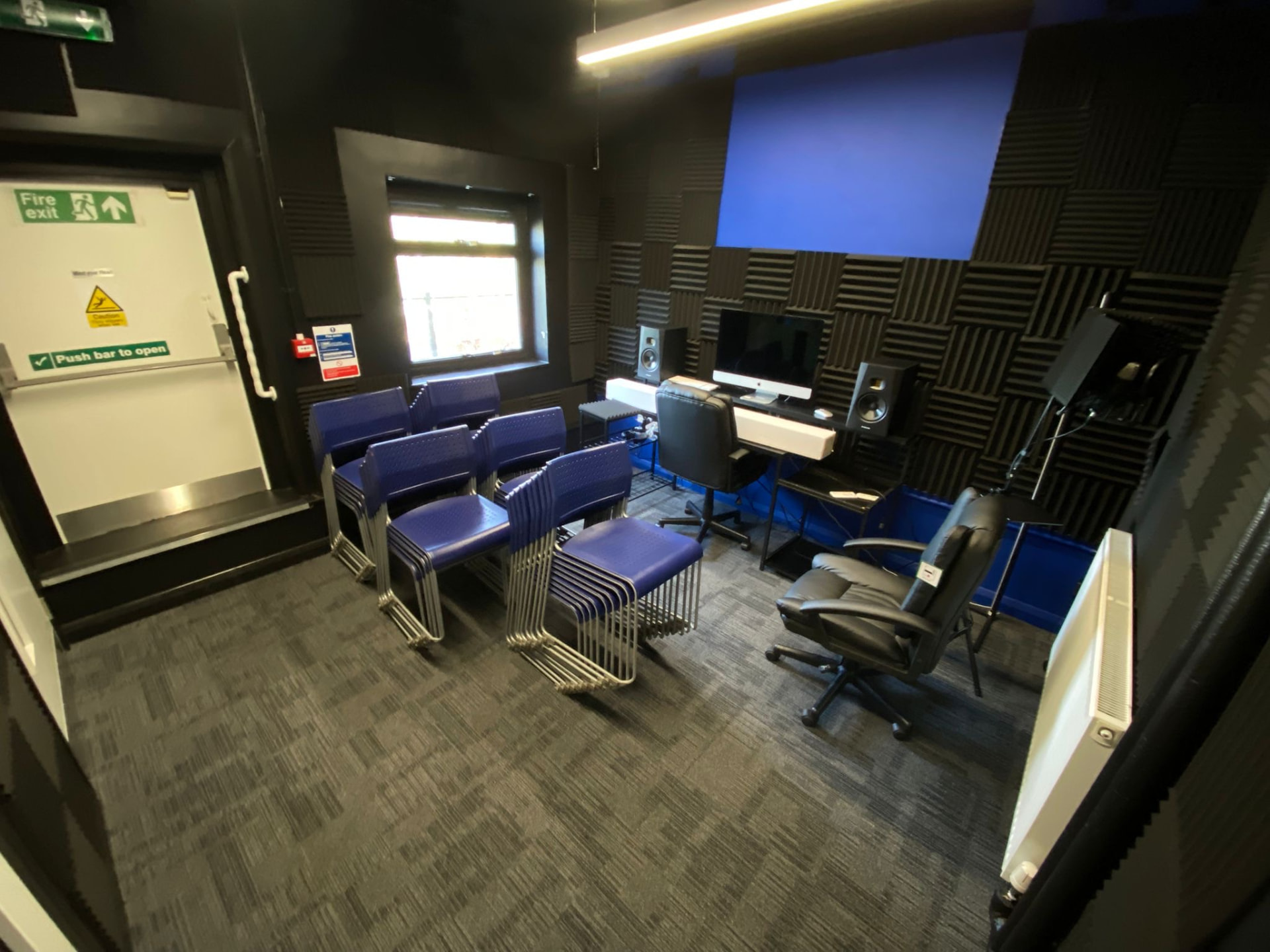 Workshop room with seating, production desk and projector screen